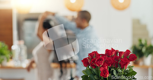 Image of Roses, valentines day and home with couple dancing for love celebration in a kitchen with waltz. Gift, flower present and floral bouquet with happy people with music, marriage and care together