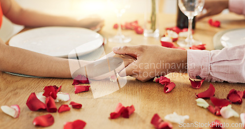 Image of Couple, roses and holding hands on dinner date, anniversary or valentines day dining by table at home. Closeup of man and woman in celebration or care for romantic honeymoon, embrace or love at house