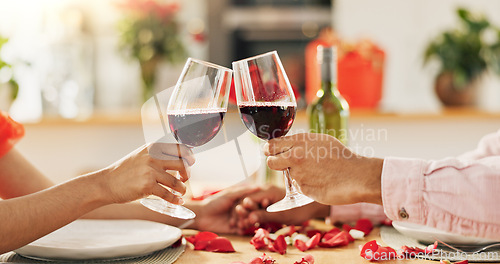 Image of Couple, hands and toast with wine glass for home celebration of love, romance and valentines day on anniversary. People, table and date success with red champagne, drinks or luxury dinner with roses