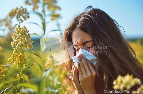 Image of Woman Blowing Her Nose in Field of Flowers