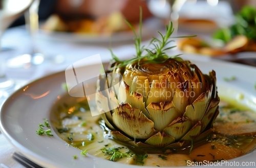 Image of White Plate With Artichoke Covered in Sauce, A Delectable Dish