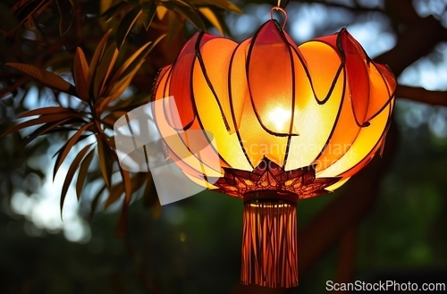 Image of Lamp Hanging From Tree in Park, Illuminating the Path in a Peaceful Natural Setting