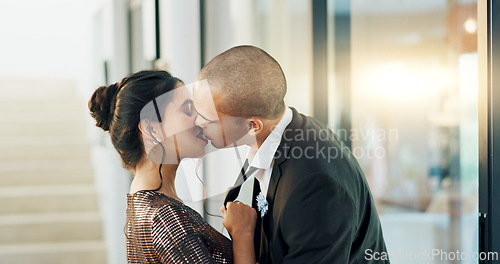 Image of Couple, love and kiss with passion on a date for formal event, intimacy and romance on valentines day at home. Lovers, woman and man in luxury house, suit and dress for anniversary or relationship