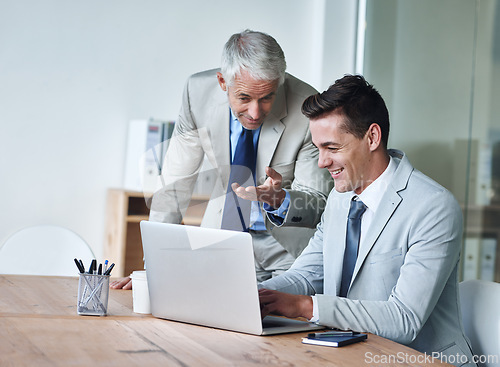 Image of Senior businessman, employee and laptop for advice, leadership and mentor on technology. Businesspeople, consulting and support or feedback on report, proposal and discussion or teaching in office