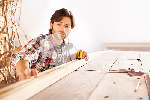 Image of Man, carpenter and wood with craft, home and tools for work, building and maintenance. Handyman, workbench and diy or craftsmen, contractor and artisan with face, thinking or planning for improvement