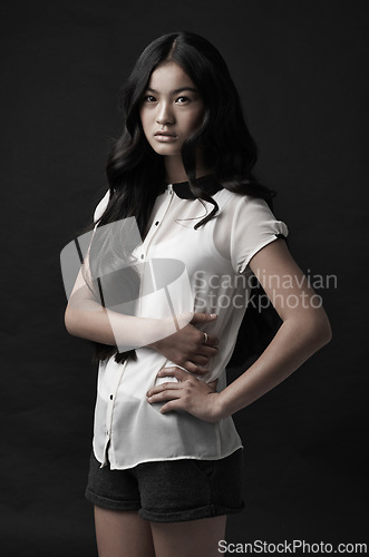 Image of Woman, portrait and fashion with style in studio or dark aesthetic or clothing confidence, black background or mockup space. Asian person, model and face or serious or Japanese beauty, cool or outfit
