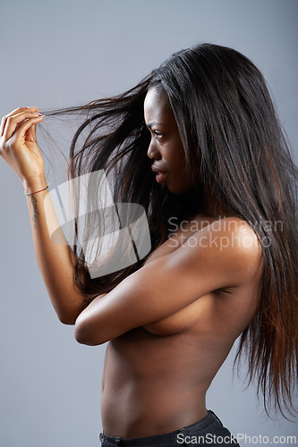 Image of Woman, thinking and hair or split treatment in studio or haircare or salon, beauty or mockup space. Black person, topless and thoughts for wellness or unhappy for dry tips, cut or grey background