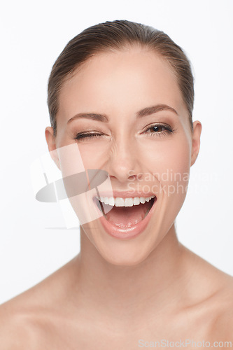 Image of Portrait, smile and woman wink for skincare, flirt or beauty makeup isolated on white studio background. Face, blink and happy model in cosmetics excited for spa facial treatment for healthy skin