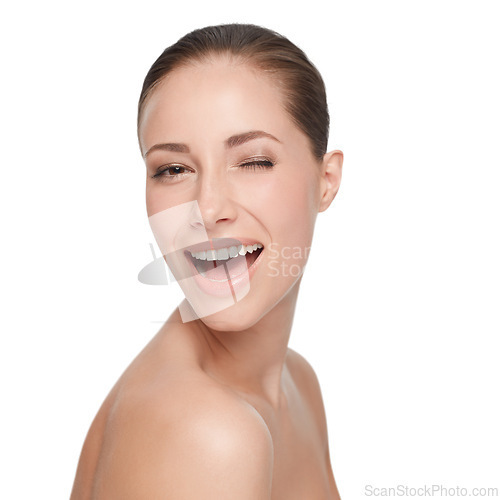 Image of Portrait, happy and woman wink for skincare, flirt or beauty isolated on white studio background. Face, blink and smile of model in makeup cosmetics excited for spa facial treatment for healthy skin