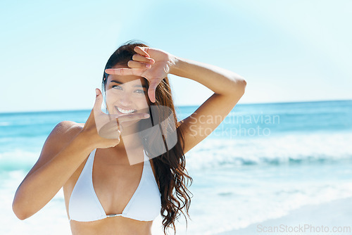 Image of Woman, beach and portrait with finger frame for smile, sign and emoji for photography with bikini in summer. Girl, person and happy in sunshine with hands by face for symbol on holiday in Naples