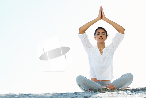 Image of Woman, yoga and meditation at beach with space, peace and zen breathing with namaste hands over head. Girl, Indian person and outdoor with mockup, nature or holiday on sand for mindfulness in Mumbai