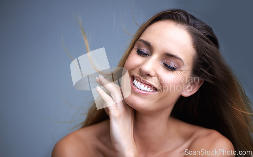 Image of Skincare, smile and woman in studio with natural, beauty and cosmetic facial routine for wellness. Health, happy and female person with face dermatology treatment by gray background with mockup.