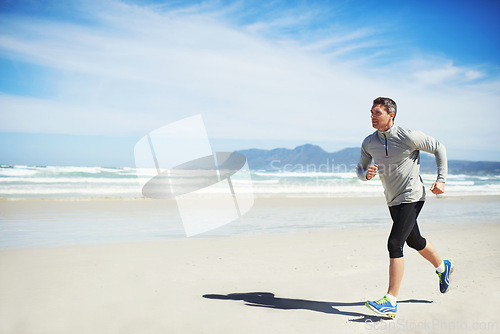 Image of Sand, space or man at beach running for exercise, training or outdoor workout at sea for fitness. Sports person, mature runner or healthy athlete in nature for cardio endurance, wellness or mockup