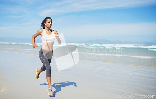 Image of Fitness, space or Indian woman at sea running for exercise, training or outdoor workout at beach. Sports person, runner or healthy female athlete on sand for cardio endurance, wellness or mockup