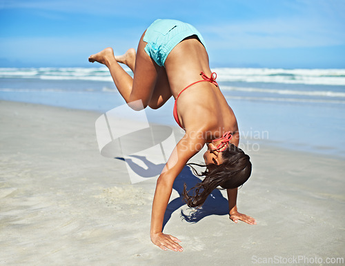 Image of Handstand, beach and woman with vacation, fitness and summer with adventure and movement. Person, seaside and girl with activity or holiday with journey and sunshine with workout or excited with trip