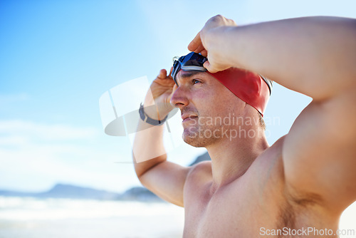 Image of Beach, goggles and man with vacation, cap and swimmer with holiday and summer break with getaway trip. Person, athlete and player with protection and seaside with sunshine and fitness with wellness