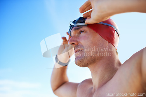 Image of Beach, goggles and man with holiday, cap and swimmer with adventure and summer break with getaway trip. Person, athlete and player with protection and seaside with sunshine and fitness with wellness