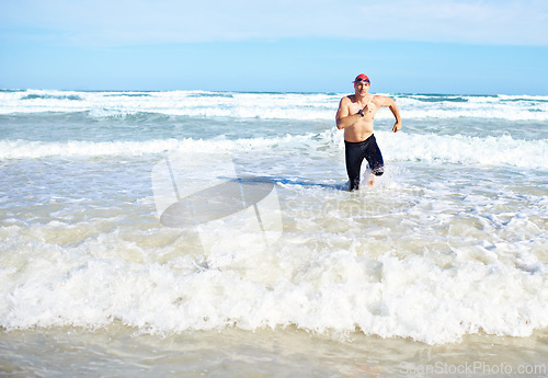 Image of Beach, running and man with fitness, summer and water with waves and exercise with morning routine. Person, seaside and runner with fun and sunshine with cardio and ocean with workout and adventure