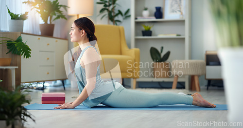Image of Exercise woman, yoga stretching and home fitness in living room floor for wellness, balance training and strong body. Healthy lady, pilates focus and flexible cobra workout training in house lounge