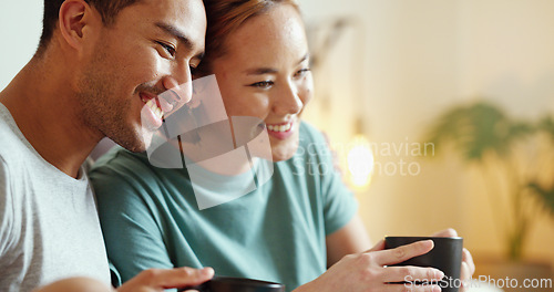 Image of Happy, coffee and laughing asian couple bonding and having fun spending time together at home. Comic, funny and content man and woman drinking tea enjoying free time at home and laugh at comedy joke