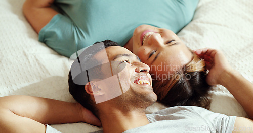Image of Happy couple, bedroom and talking while lying on bed for love and marriage bonding happiness in comfy home. Asian man and woman joke and relax in romantic hotel together in morning from above
