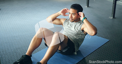 Image of Fitness, man and doing sit ups for wellness, health and motivation doing workout routine, exercise and training in gym on floor. Male trainer, athlete and movement being healthy, strong and focus.