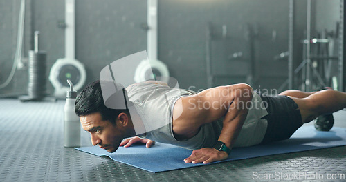 Image of Fitness, man and pushups for muscle, exercise or training workout for strength or power at the gym. Athletic male in sport exercising lifting body with arms on the floor for strong muscles indoors