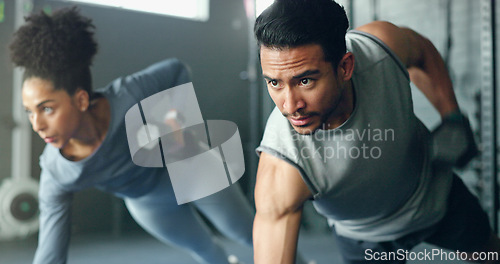 Image of Fitness, gym and dumbbell, people doing weightlifting and exercise for body training with focus and strong muscle. Man, woman and workout on mat, endurance and serious athlete for active lifestyle.