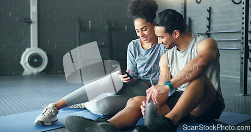 Image of Smartphone, fitness and personal trainer talking to client for exercise goal planning on mobile app, internet search or health software. Young sports people on floor in conversation and using phone