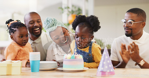 Image of Birthday, children party and applause with a family in celebration of a girl child in their home. African parents, grandparents and kids clapping while blowing candles on a cake at a milestone event