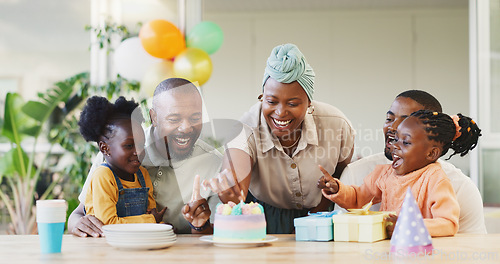 Image of Black family, birthday cake and candles for children to celebrate with parents at a table. African woman, men and happy kids at home for a party, quality time and bonding or fun with love and care