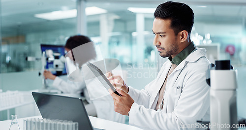 Image of Scientist, man and tablet for laboratory research, DNA analysis and results in medical study at night. Young science expert or people in biotechnology, digital software or computer for test checklist