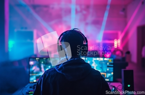 Image of Person Wearing Headphones in Front of Computer for Work or Study