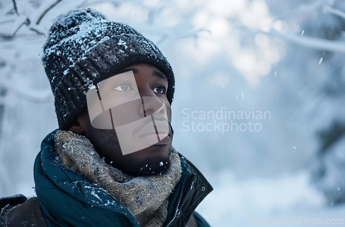 Image of Man Wearing Hat and Scarf in Snow, Winter Outdoor Scene With Cold Weather Attire