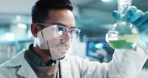 Image of Serious man, scientist and beaker with chemical for research, experiment or test in lab. Science, medical professional and shake glass for development of cure, biotechnology and study for healthcare
