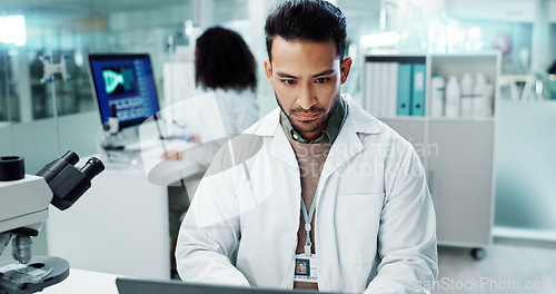 Image of Scientist, man and reading computer for laboratory test, typing report or medical results of DNA at night. Asian expert thinking on computer for science research, biotechnology and molecule analysis