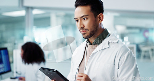 Image of Man, thinking or scientist with tablet in laboratory or online research of genetics in healthcare. Asian doctor, reading or idea in digital pharmaceutical database or smile for medicine breakthrough