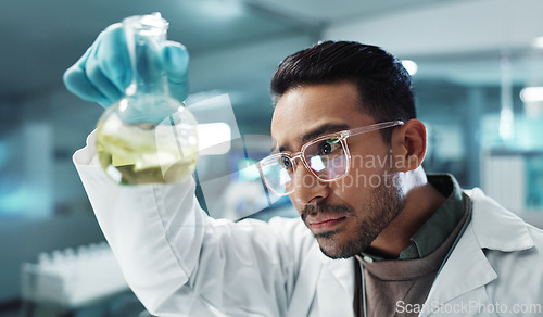 Image of Man, scientist and shake beaker with chemical for research, experiment or test in lab. Science, serious or medical professional with glass for development of cure, biotechnology or study healthcare