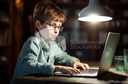 Image of Young Boy Sitting in Front of Laptop Computer