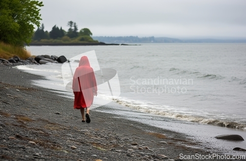 Image of Solitary walk along a pebbled shore