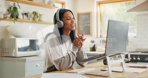 Image of Laptop, headphones and video call with a woman entrepreneur in the kitchen of her home for small business. Computer, virtual meeting and a young freelance employee remote working from her house