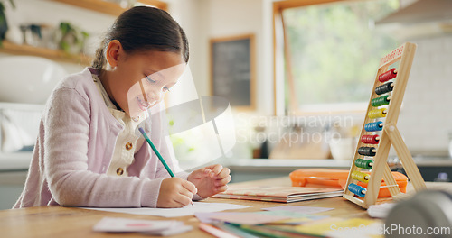 Image of Education, writing and happy girl child in a kitchen with maths, homework or counting practice in her home. Learning, creative and female kid smile while drawing on a table for homeschool math lesson