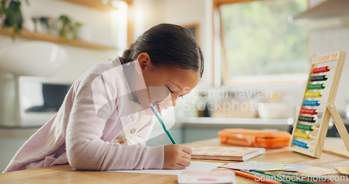 Image of Learning, writing and happy girl child in a kitchen with maths, homework or counting practice in her home. Education, creative and kid student smile while drawing on table for homeschool art lesson