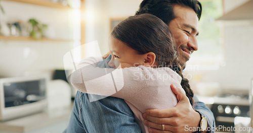 Image of Children, father and daughter hug in the kitchen for love, trust or bonding together in their home. Family, smile and safety with a happy young man embracing his adorable girl child in their house