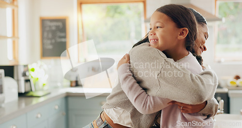 Image of Love, mom and girl in a hug in family home with support, trust and bonding in kitchen or happy childhood memory of daughter. Smile, face and kid in embrace with mother, woman or together with mommy