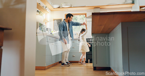 Image of Support, love and ballet girl bonding with father in a kitchen together, excited and playing as a dancer pr ballerina. Tutu, dad and man dancing with kid with motivation or happiness in house or home