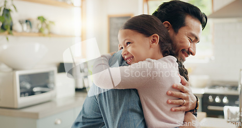 Image of Family, father and daughter hug in the kitchen for love, trust or bonding together in their home. Kids, smile and safety with a happy young man embracing his adorable girl child in their house