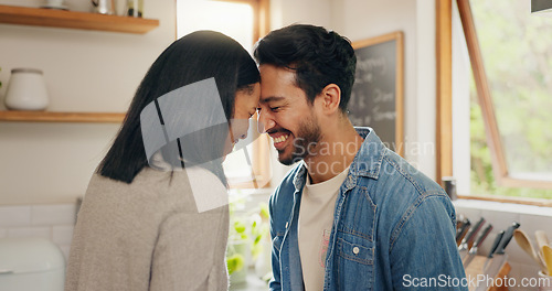 Image of Love, hug and happy couple in a kitchen talking, together and intimate while bonding in their home. Embrace, romance and man with woman hugging, smile and sharing moment, conversation and laughing