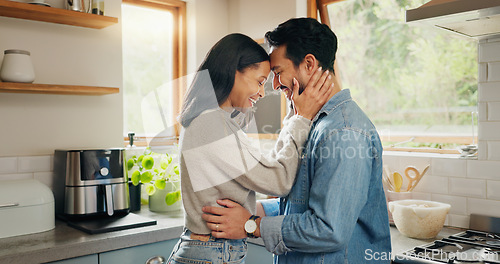 Image of Hug, happy and couple in a kitchen bonding, intimate and talking in their home together with intimacy. Love, face and woman embrace man with smile, care and sharing romantic moment and conversation