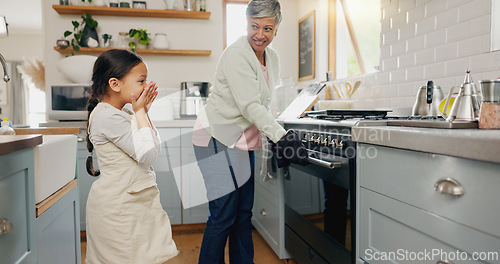 Image of Kitchen, food and grandmother cooking with child learning to prepare dinner, supper or lunch in a home. Grandchild, support and grandma baking with kid or girl and happy for a fresh meal together